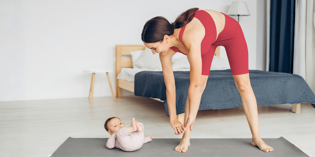 A monther is doing Yoga.