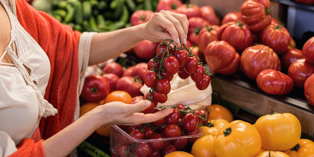 A lady is currently picking out some fruits.